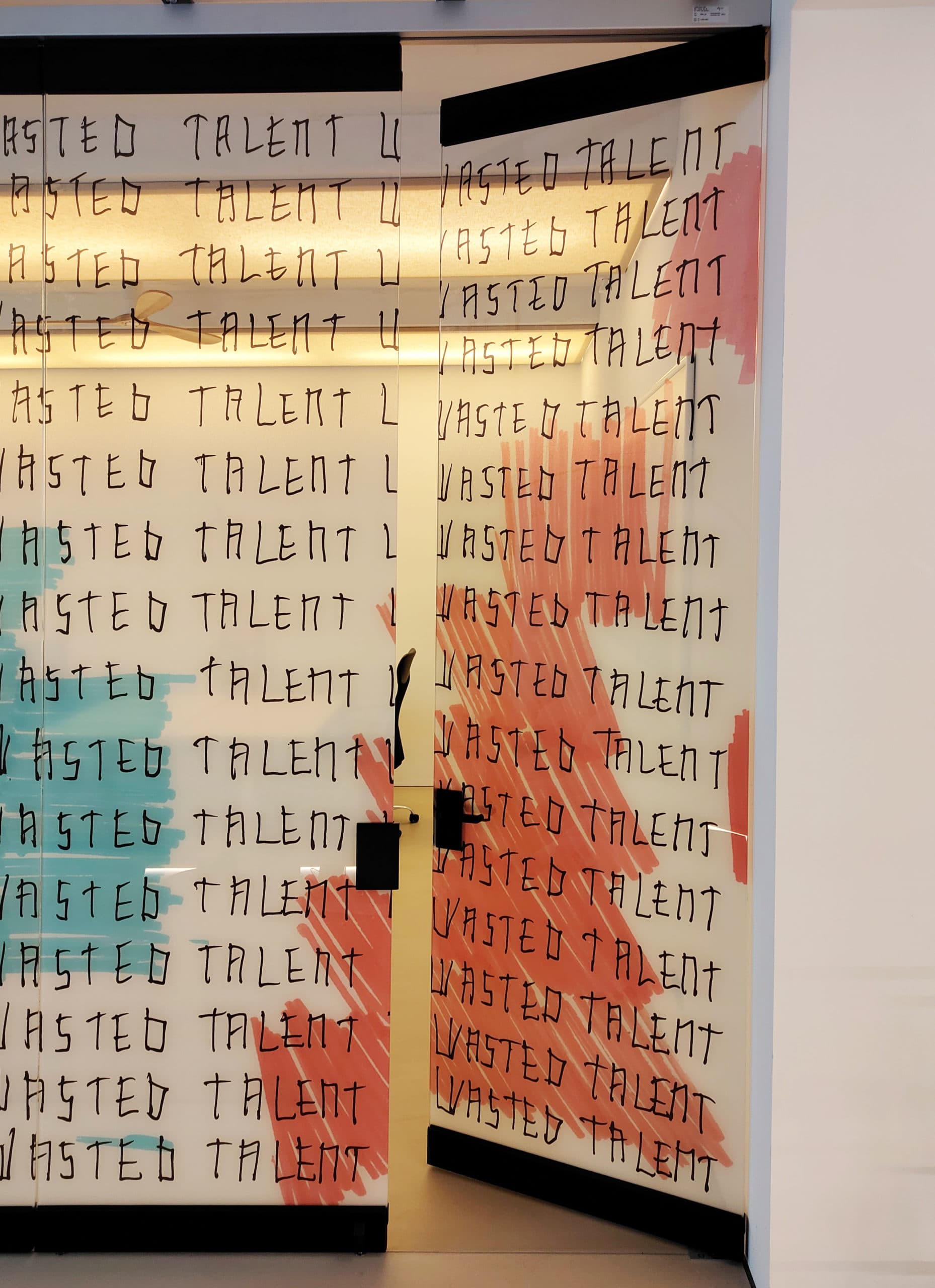 Printed glass wall with door for Wasted Talent Studios — office interior design