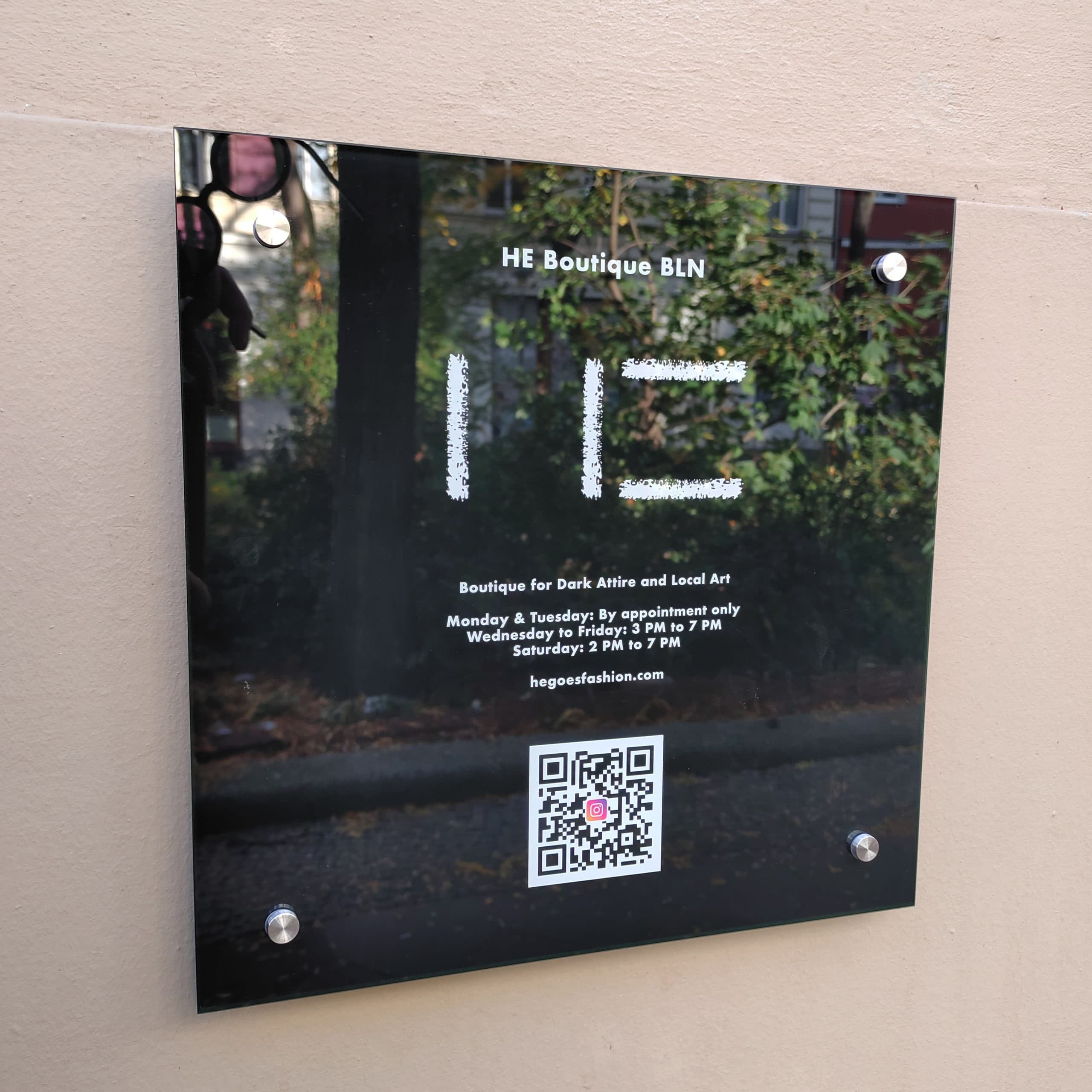 Printed glass shop sign with QR code for HE Boutique, Berlin-Kreuzberg