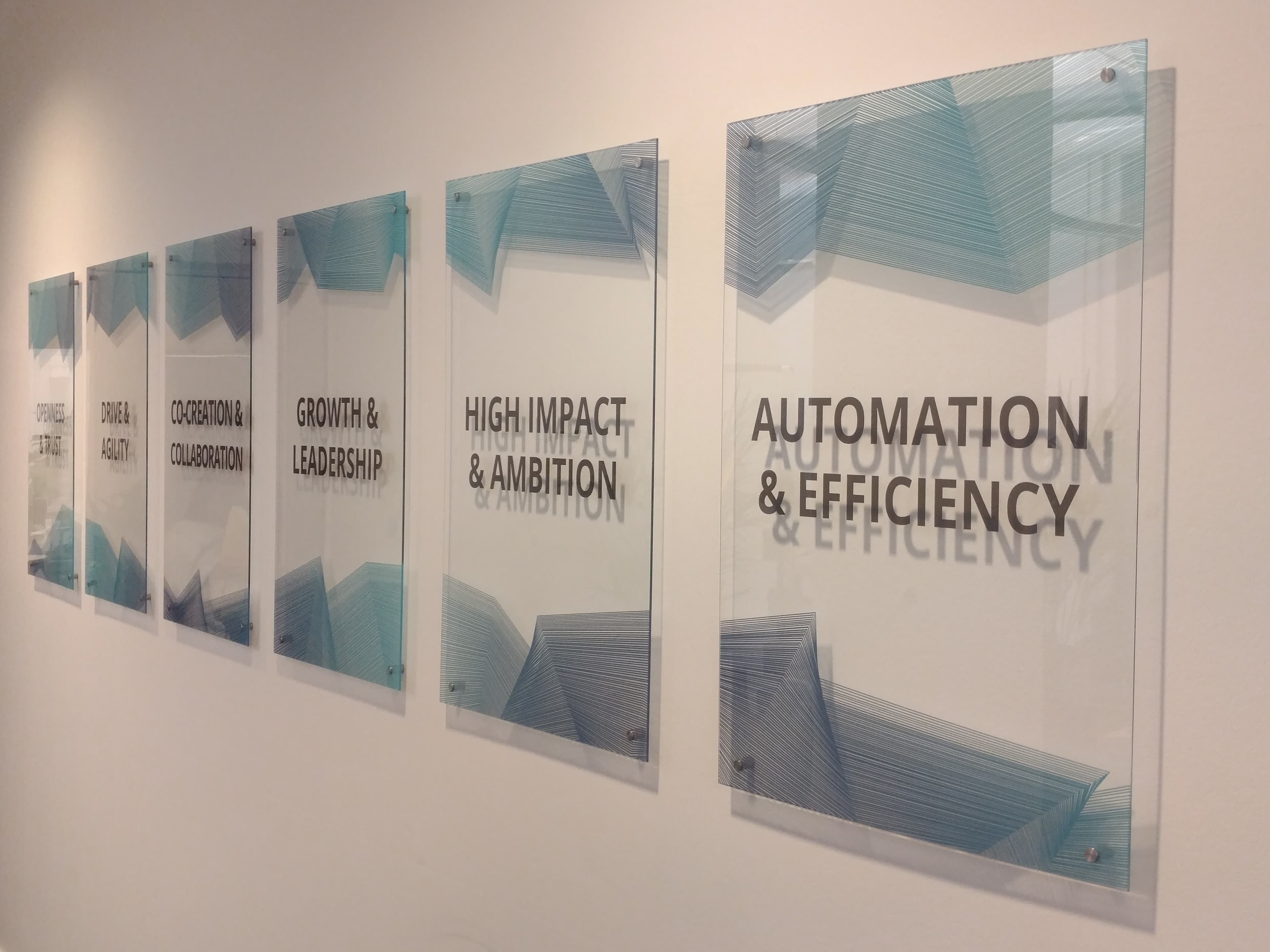 Company values printed on 6 glass panels β office interior installation Berlin