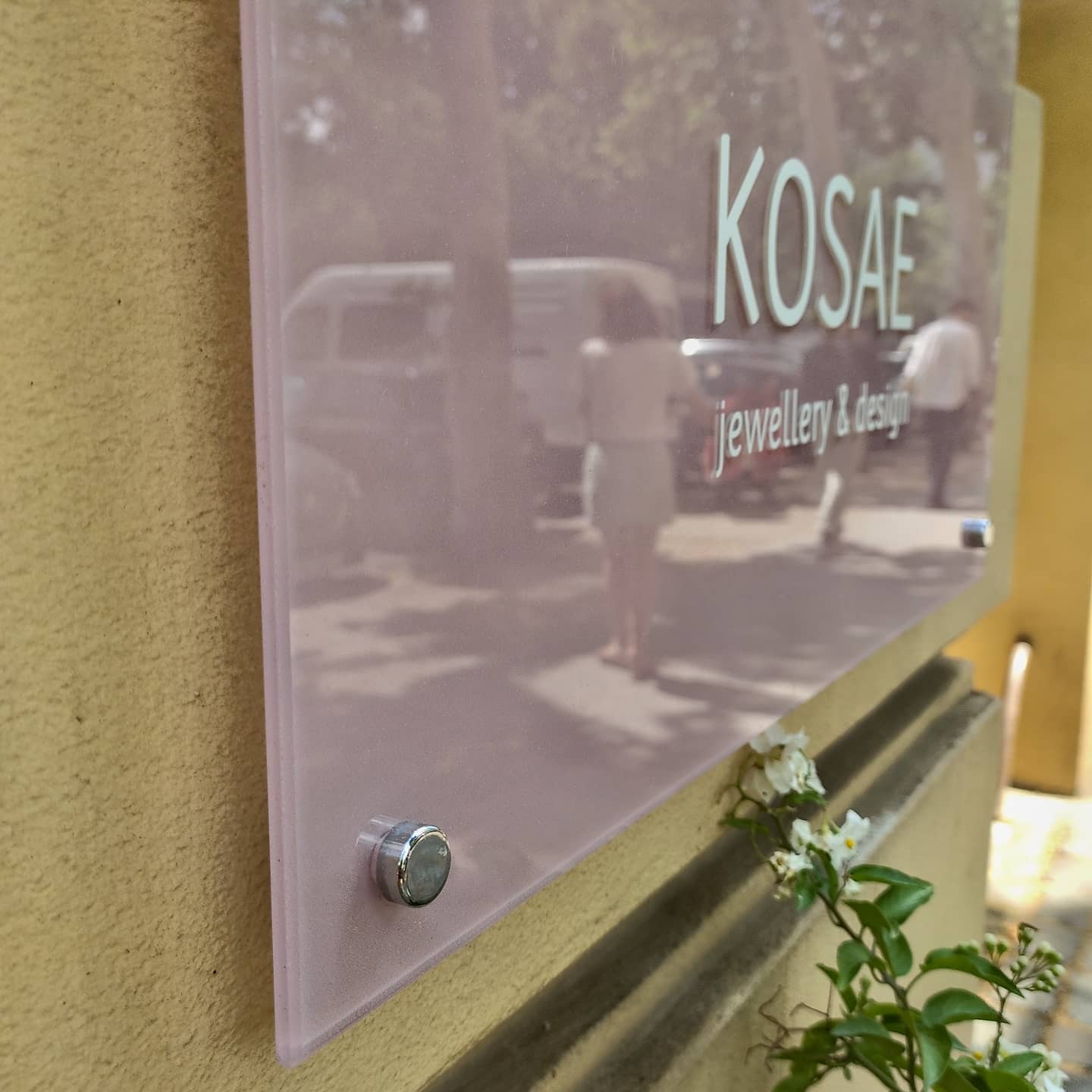 Translucent glass sign with shadow effect โ @kosae_jewellery, Berlin